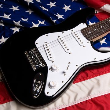 black and white guitar resting on american flag