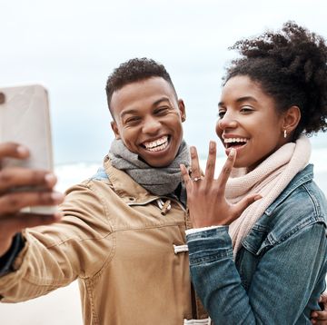 cropped shot of a young couple taking a selfie at the beach