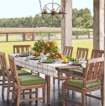 covered outdoor porch with a formal dining table set up