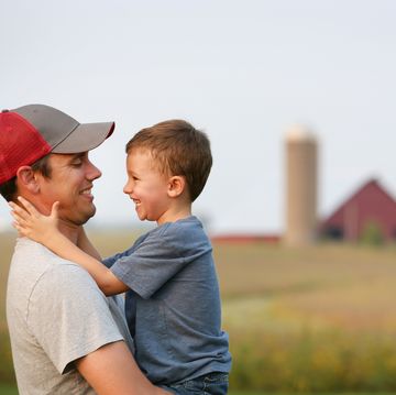 a father and son hug each other on their family farm