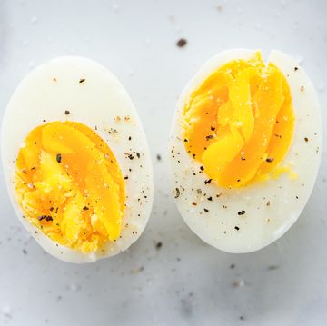 hard boiled eggs cut in half and seasoned with salt and pepper on marble surface