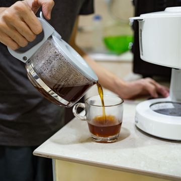 a man making coffee with drip coffee maker