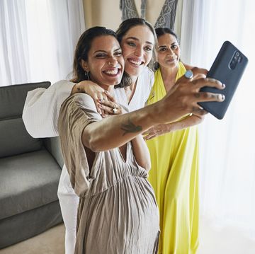 mom and daughters taking selfie