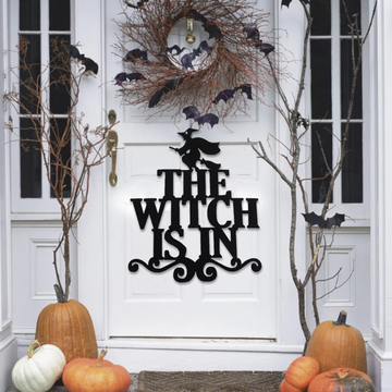 door sign that says the witch is in